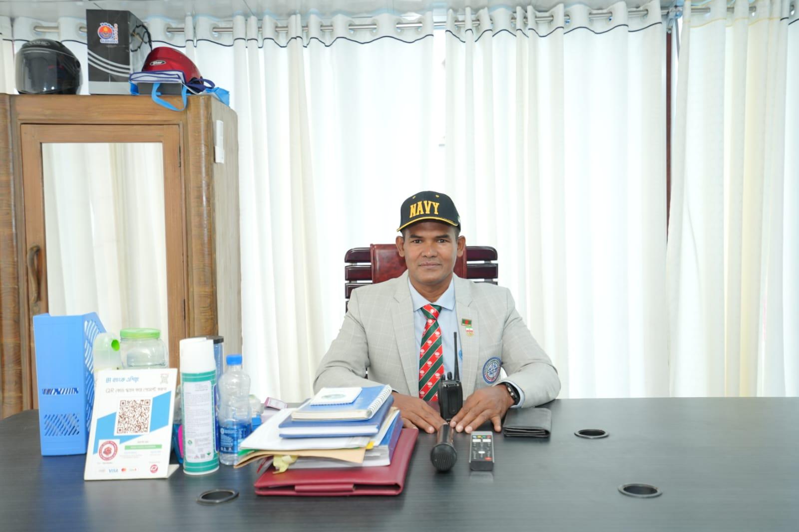 Monir Hossain, founder of Monir Fokir Swimming Complex, at his office desk